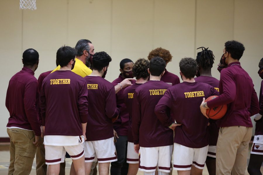 Men’s basketball team huddles up before their game against DePauw University on January 25th. (Photo Credits/Justin Bjorseth)