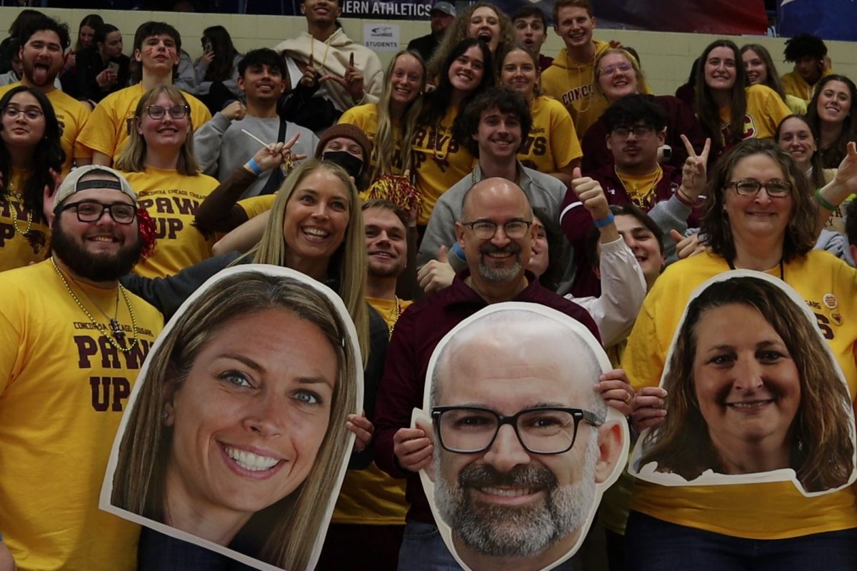 CUC Football Player Jacob Garrison; Concordia University Chicagos  Dean of Students, Kathy Gebhardt; President, Russell Dawn; and Director of Athletics, Janet Wolbert, joining the CUC Student Fan section