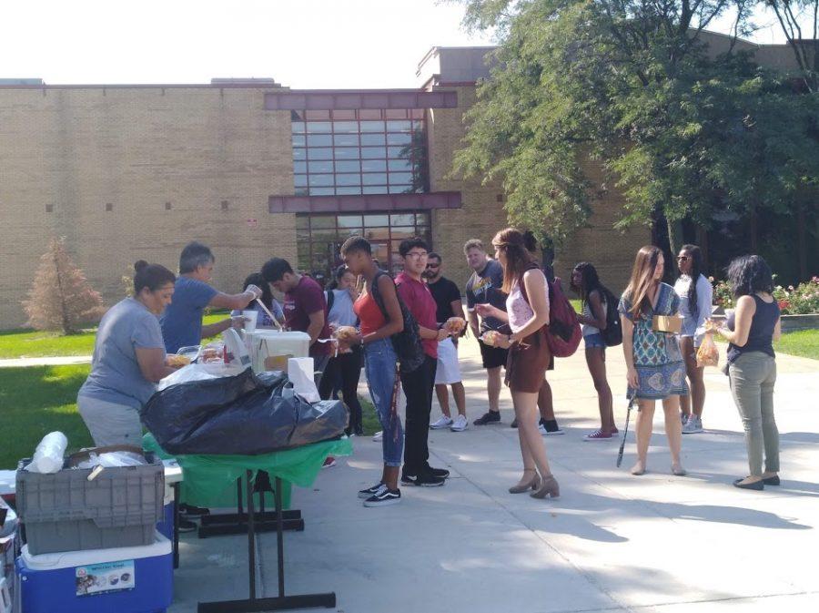 Vendors giving students Mexican street food