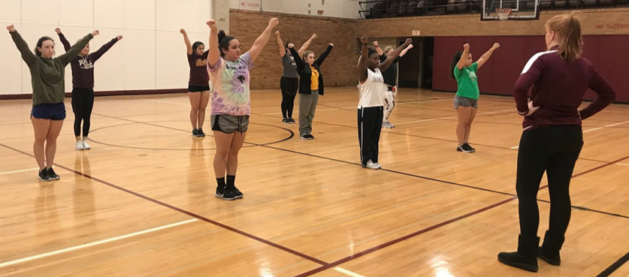 The head Cheerleading coach, Molly Maas, is instructing her team on arm motions in the South Gym at Concordia University Chicago on Wednesday, November 6, 2019. (Photo Credit to Destiny Henschel)