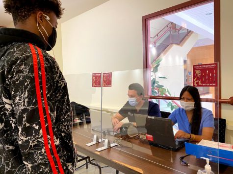 Stefan Kovacevic, M.D, and Tylar Pon, R.N., check in students in CC 200 for their on-campus COVID test on Thursday January 28th, 2021.