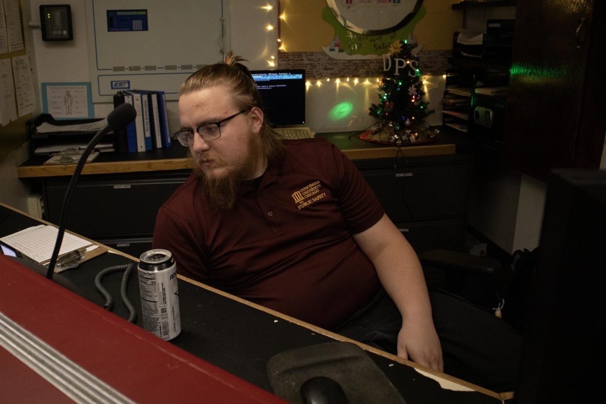 Dispatcher Andrew Kuhnau, responding to a call at the Department of Public Safety front desk on Dec. 1.