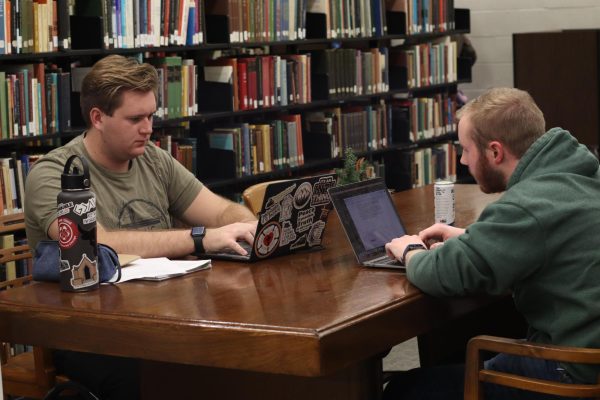 (Left to Right )Junior Clark Stutsman, and sophomore Elijah Kohlmeier, doing a creative writing assignment in the Klinck Memorial Library on Dec.12.