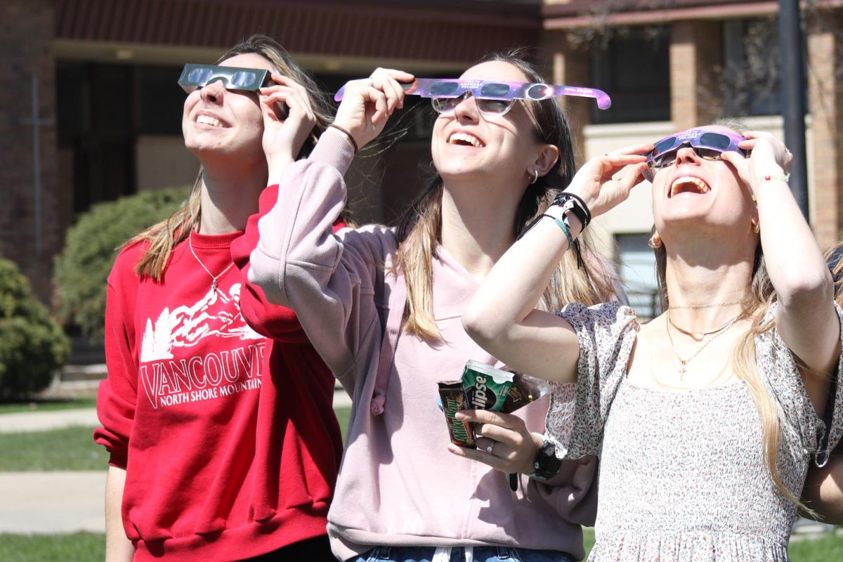 Maddie Swets, Callie Hoover, and Mckenna Stanley viewing the April 8 solar eclipse in the Triangle.