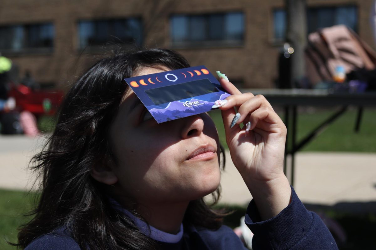Junior, Natalie Salinas, viewing the Solar Eclipse in the Concordia University Chicago Triangle on April 8th, 2024