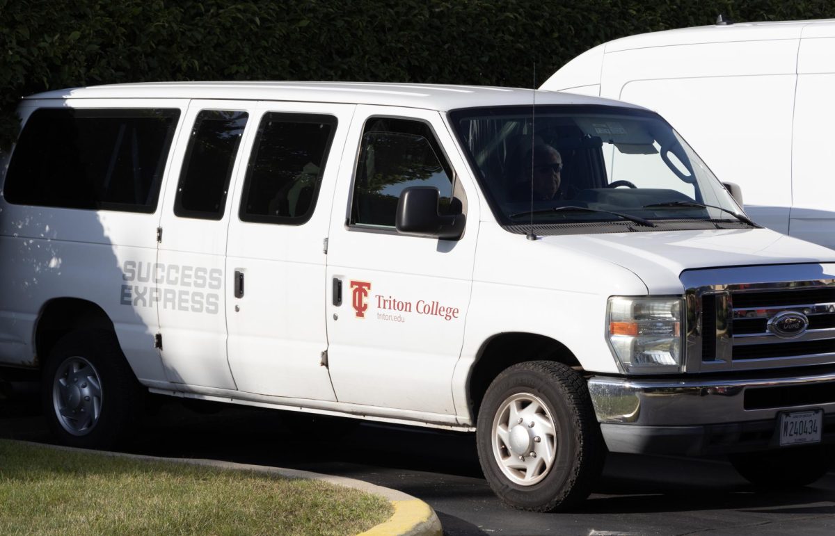 Tritton Shuttle Bus parked at the Krentz Center visitor parking lot waiting to transfer Triton Students.