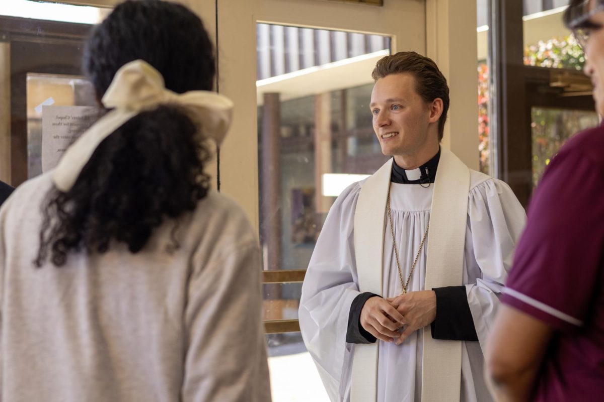 Concordia Chicago's University Chaplain, Simeon Raddatz, attending the Latino Student Union's All Saints' Day Celebration in the Narthex of Krenztmann on Friday, November 1st.