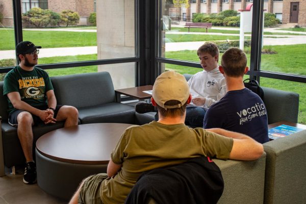 Junior Tim Meyer, freshman Connor Nicols, freshman Jack Starich, and junior Elijah Kolmeier hang out in Kay's Corner on April 22