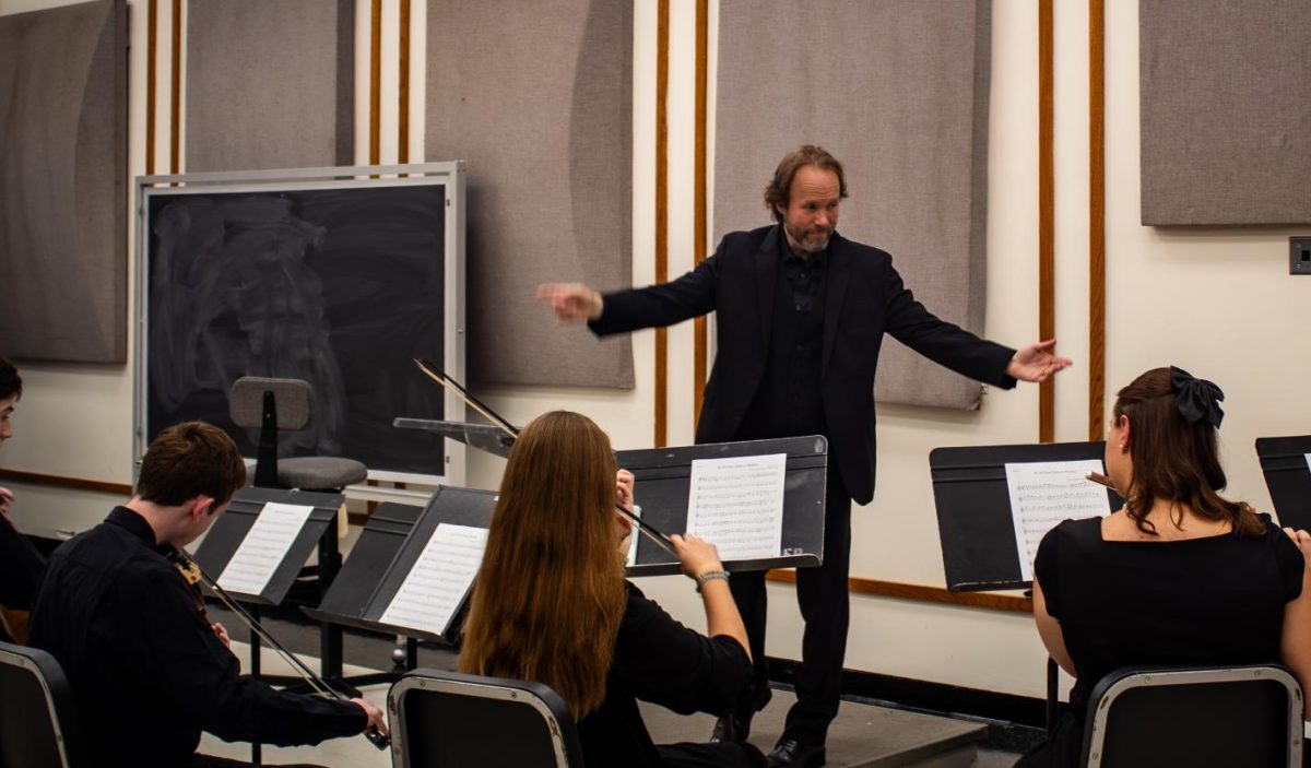 CUC music professor Maurice Boyer conducts orchestra rehearsal on Sept. 17