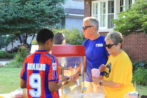 Volunteers serve popcorn to LemonAid attendees on September 11, 2025.