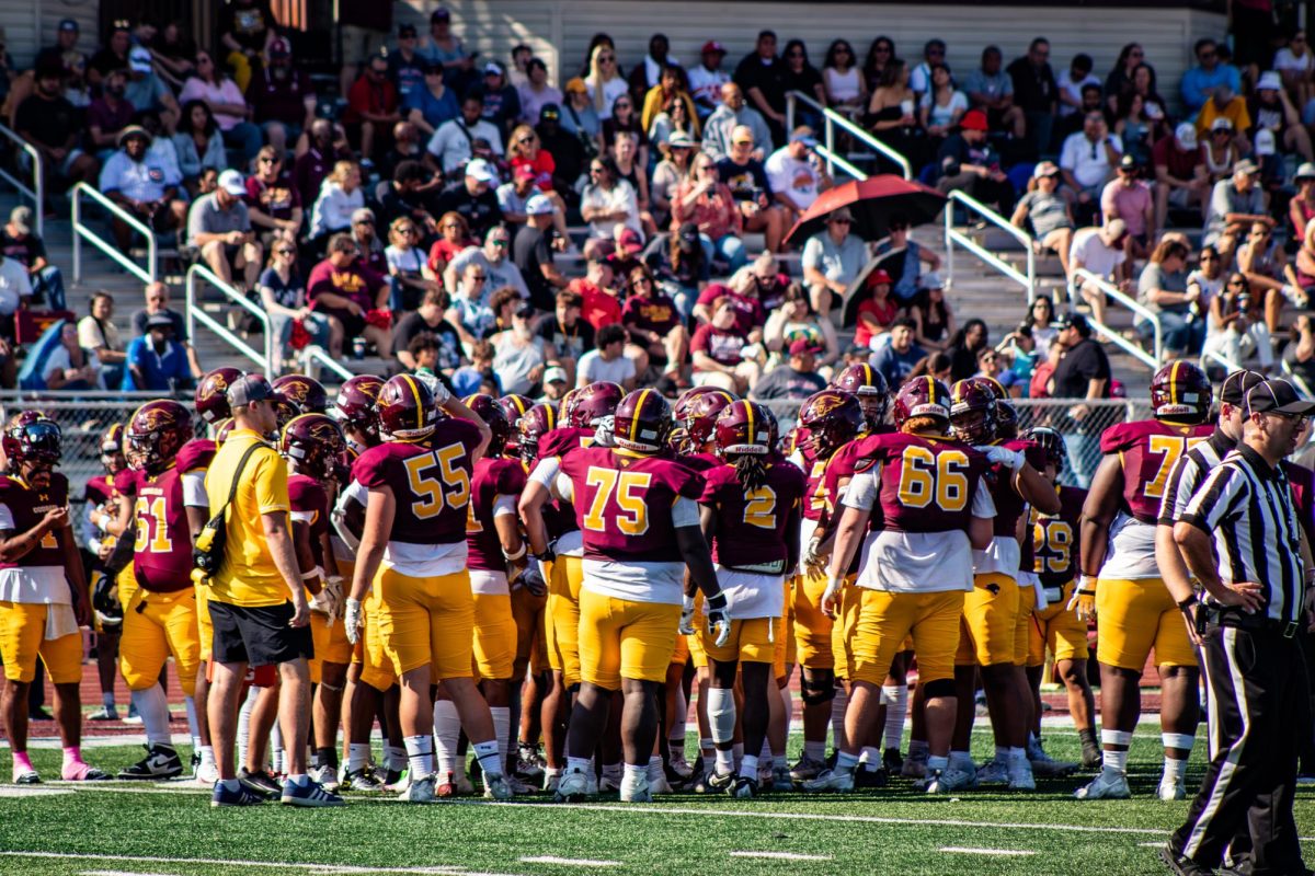 Football players huddle together and support each other during the 2025 Homecoming game October 4th