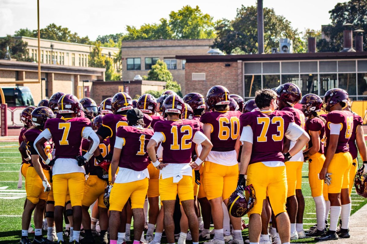 Football players huddle together and support each other during the 2025 Homecoming game October 4th