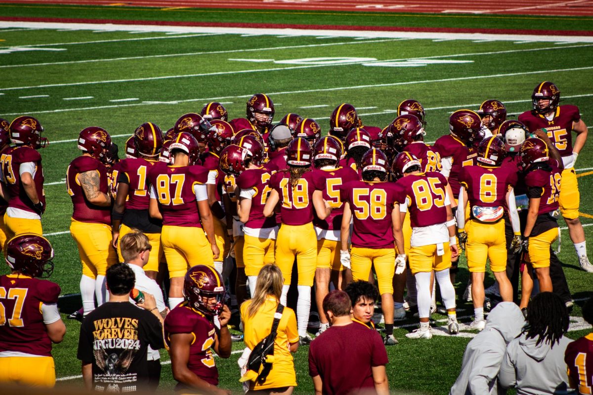 Football players huddle together and support each other during the 2025 Homecoming game October 4th