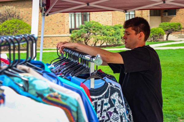 Sophomore Dayton Merli prepares his vintage clothing for the Entrepreneur Fair on April 17.