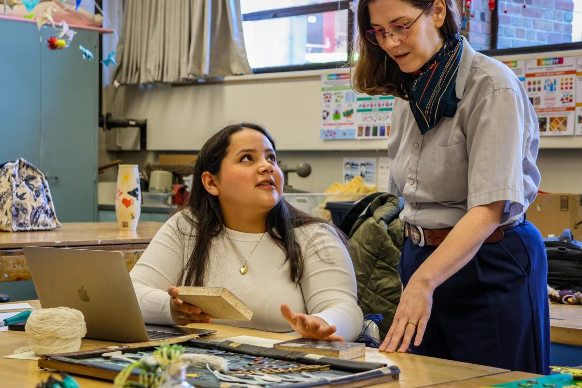 Senior Isabelle Campos works with Professor Dieffenbach on art piece in an Advanced Studio class.