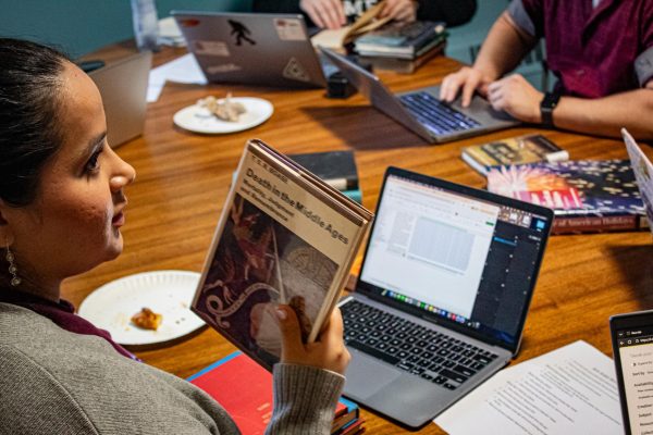 Senior Isabelle Campos categorizes books from CUAA library to donate to CUC library