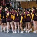 Cheer athletes prepare for a meet at Geiseman Gymnasium in 2025