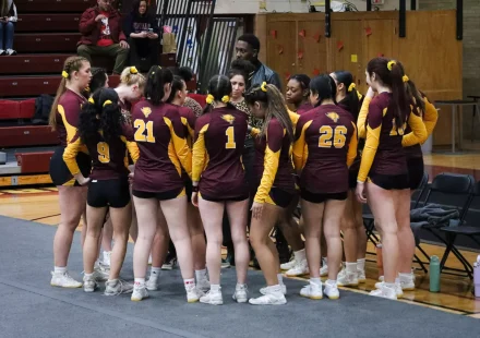 Cheer athletes prepare for a meet at Geiseman Gymnasium in 2025