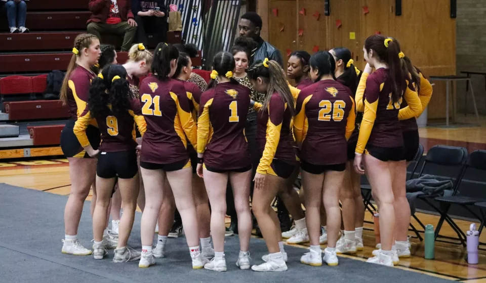 Cheer athletes prepare for a meet at Geiseman Gymnasium in 2025