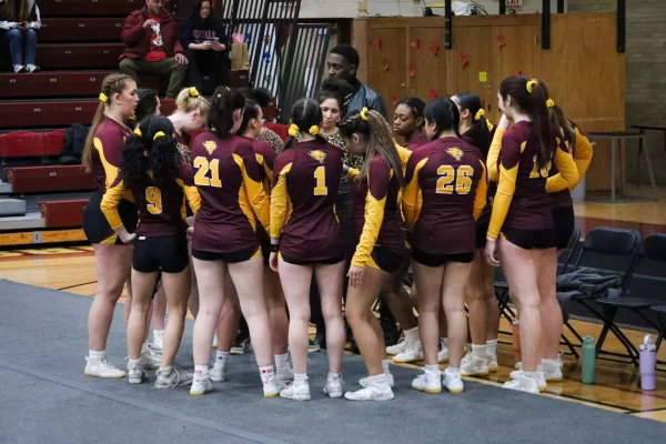 The 2025 cheer team preparing for a competition inside Geiseman Gymnasium.
